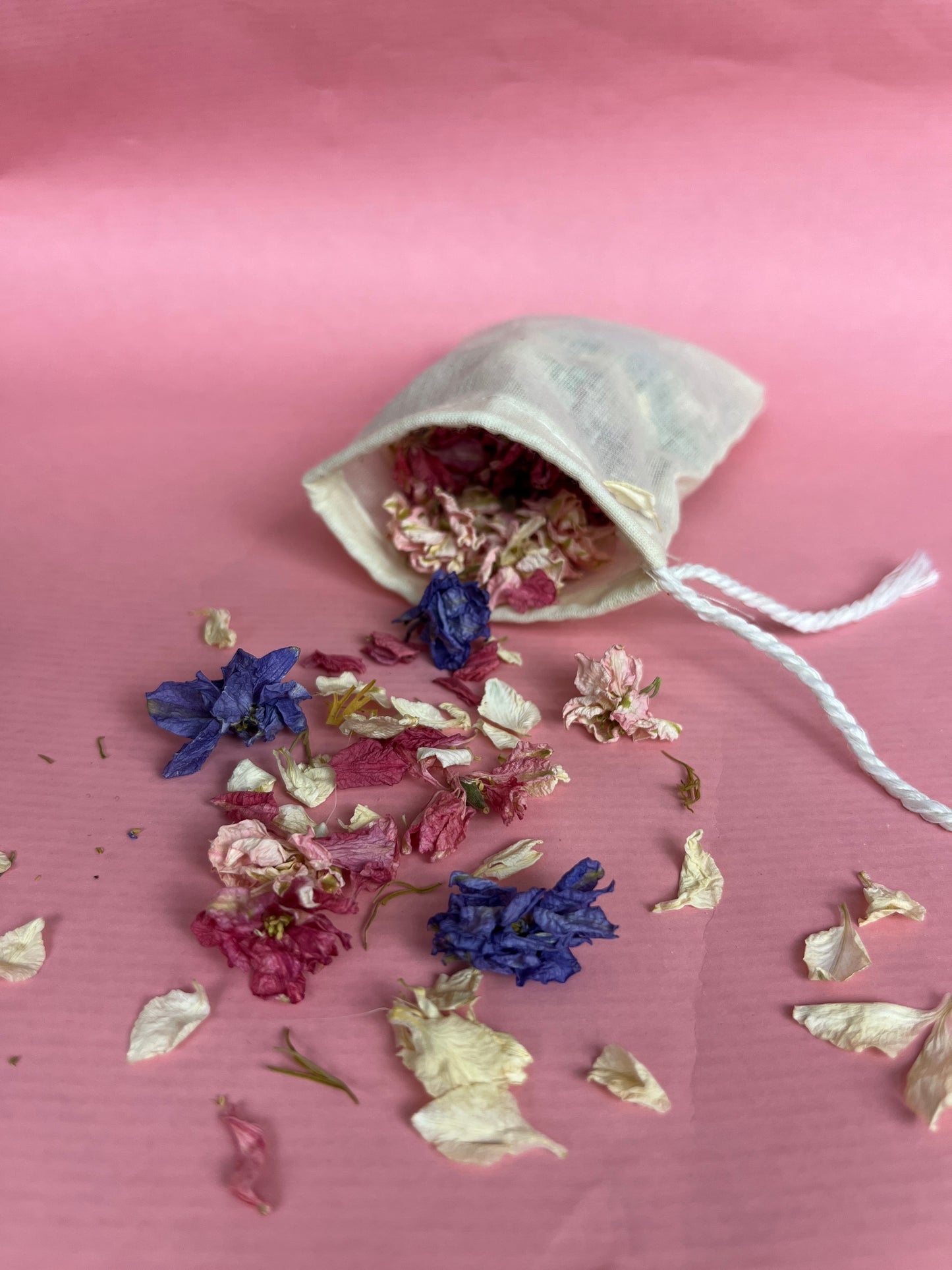 Pouch with eucalyptus and lavender leaves on a pink background