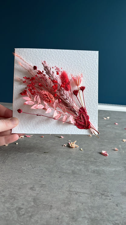 Kayleigh holding a pink dried flowers card 