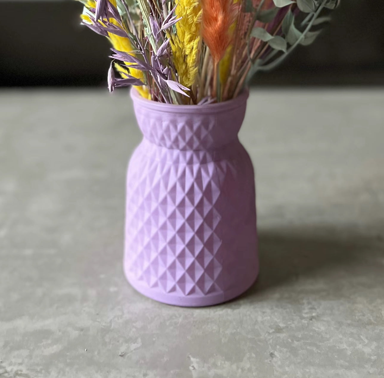 Purple meadow glass vase displayed on the table