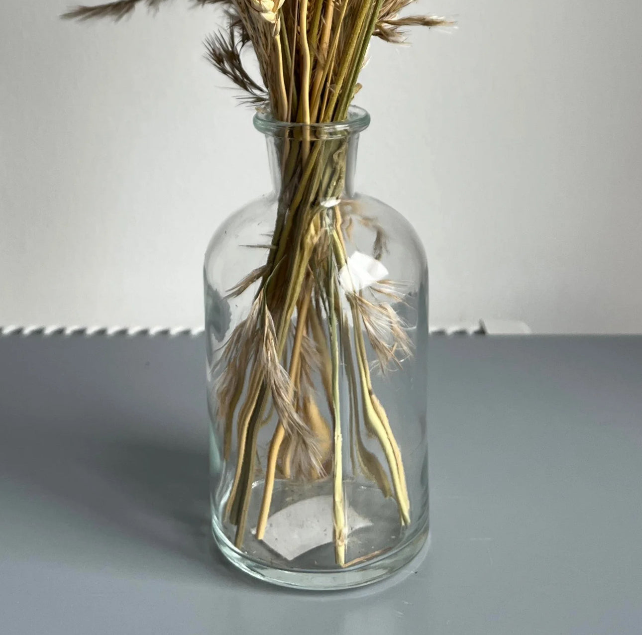 Clear bottle vase displayed on a table 