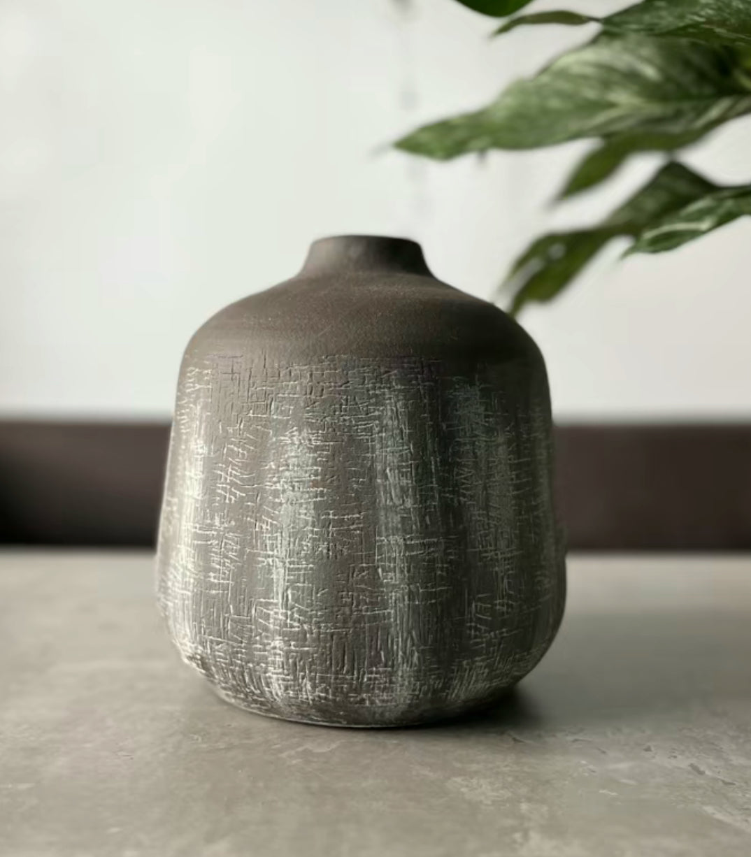 Terracotta stone colour vase in the shade brown being displayed on a table