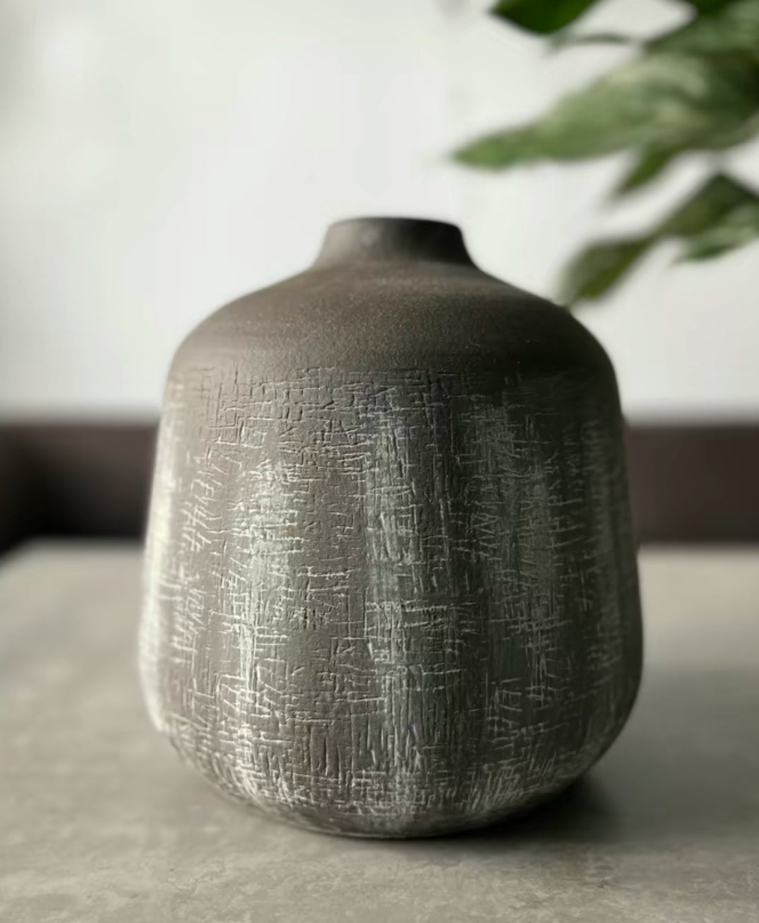 Terracotta stone colour vase in the shade brown being displayed on a table