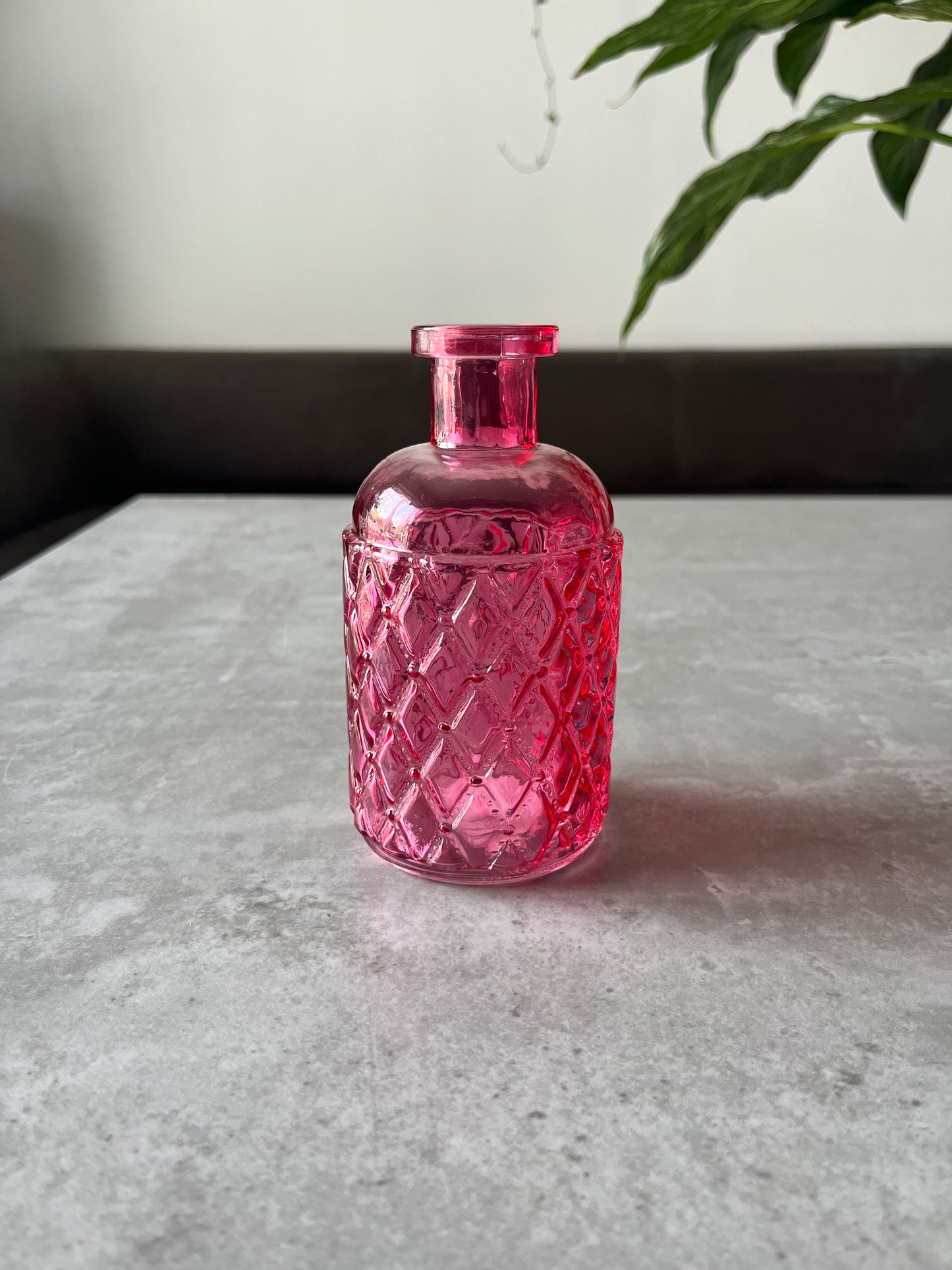 Pink bottle vase displayed on a table